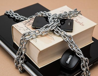 censorship-limitations-freedom-of-expression-restricted-39584-39584 Chain-locked book, phone, and laptop symbolizing digital and intellectual security.
